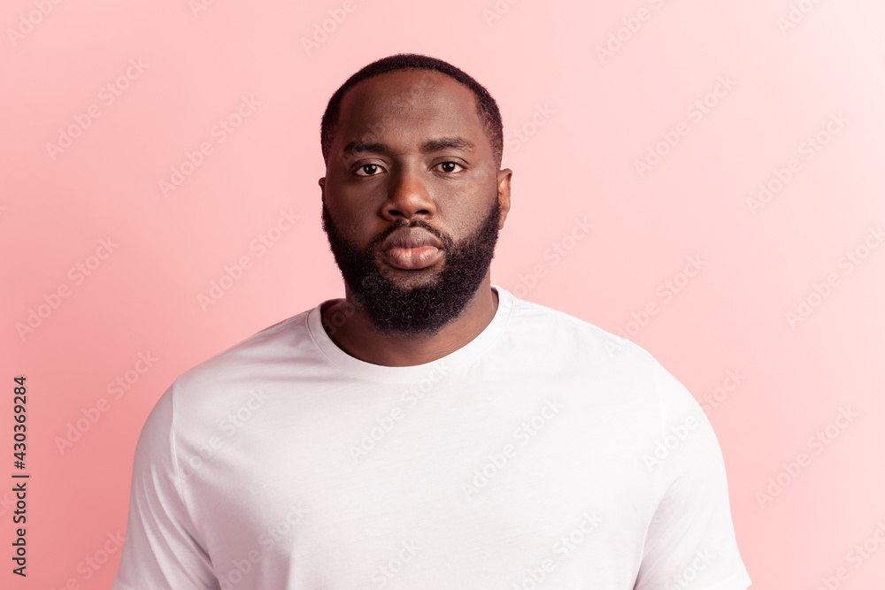 Portrait of handsome man serious face look camera on pink wall Portrait of handsome man serious face look camera on pink wall