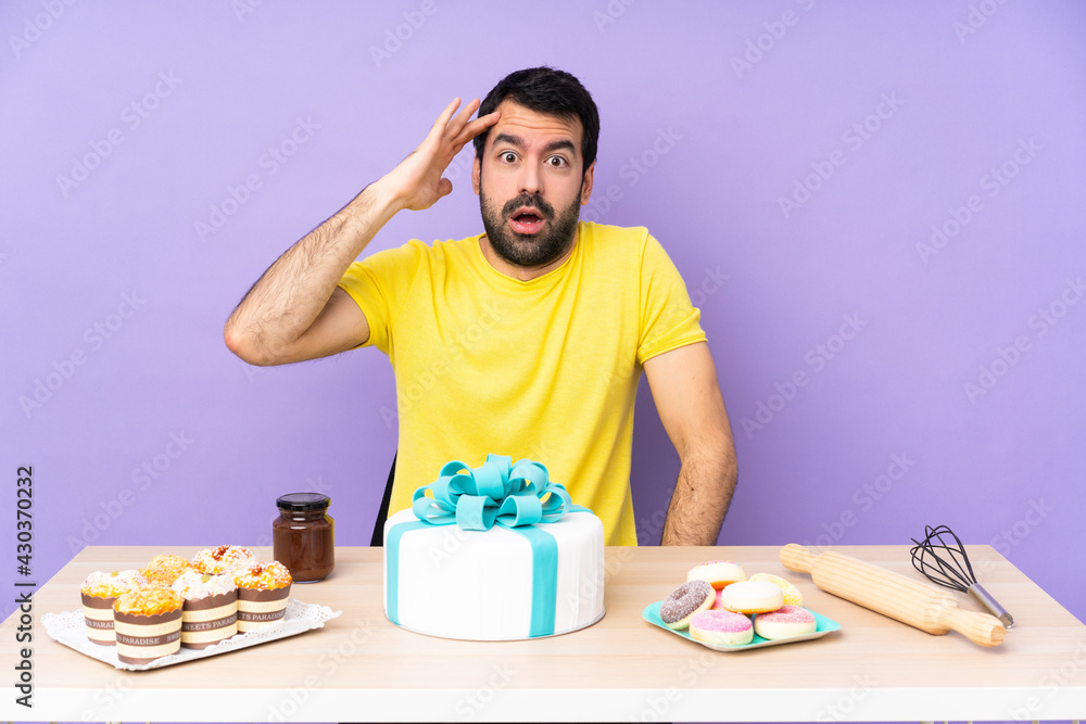 Man in a table with a big cake has just realized something and has intending the solution Man in a table with a big cake has just realized something and has intending the solution