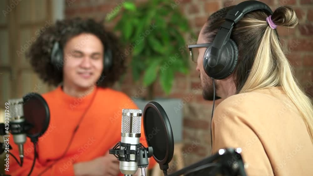 Man colleagues recording podcast for radio together in studio Spbd. Two people men at work talk Man colleagues recording podcast for radio together in studio Spbd. Two people men at work talk