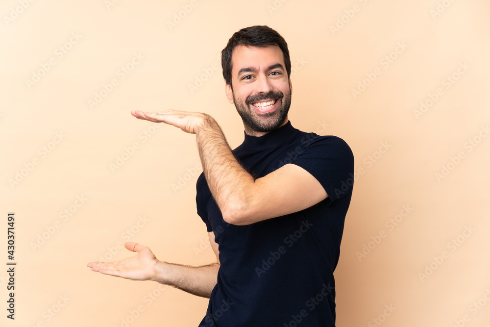 Caucasian handsome man over isolated background holding copyspace to insert an ad Caucasian handsome man over isolated background holding copyspace to insert an ad