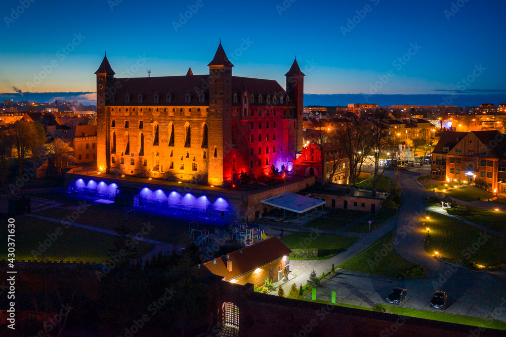 Teutonic castle in Gniew town illuminated at night, Poland