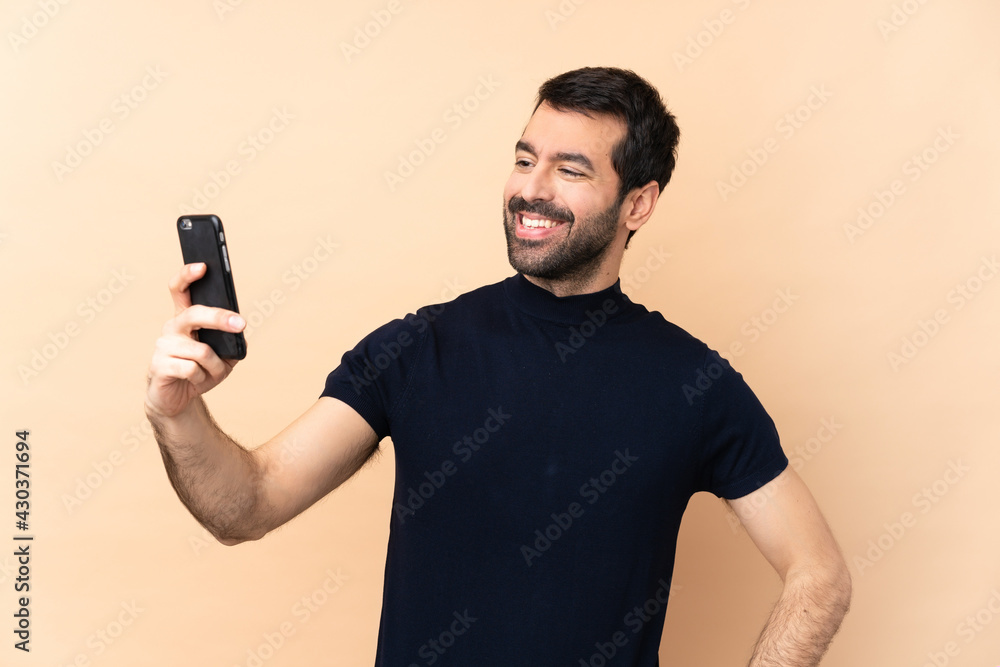 Caucasian handsome man over isolated background making a selfie Caucasian handsome man over isolated background making a selfie