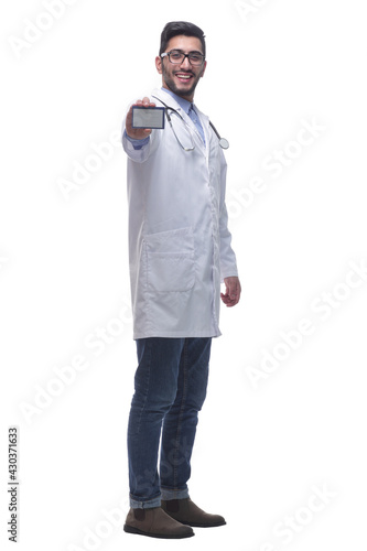 smiling doctor showing his business card. isolated on a white background. © ASDF