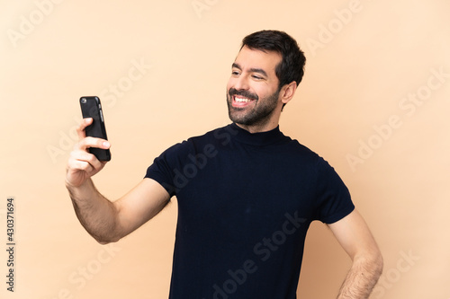 Caucasian handsome man over isolated background making a selfie