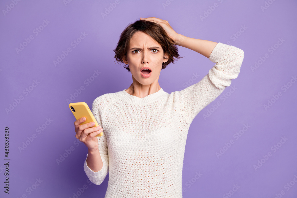 Photo portrait of girl with bob hair misunderstanding unsure reading information isolated on pastel purple color background Photo portrait of girl with bob hair misunderstanding unsure reading information isolated on pastel purple color background