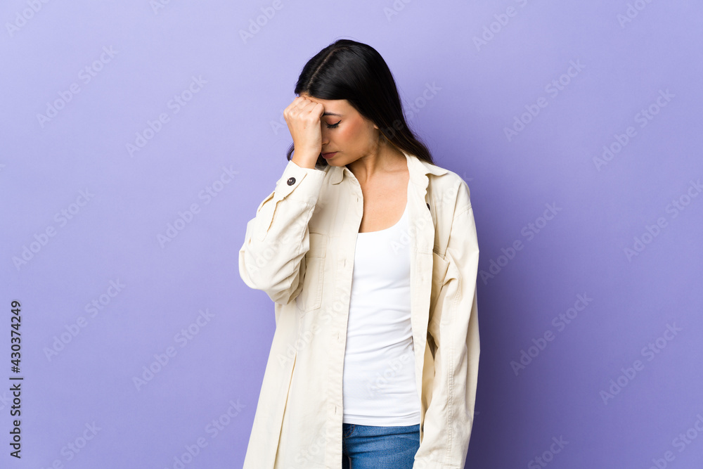 Young brunette woman over isolated purple background with headache Young brunette woman over isolated purple background with headache