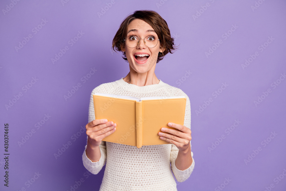 Photo portrait of cheerful smart woman reading book studying in glasses isolated on pastel purple color background Photo portrait of cheerful smart woman reading book studying in glasses isolated on pastel purple color background