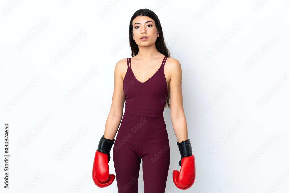 Young sport woman over isolated white background with boxing gloves