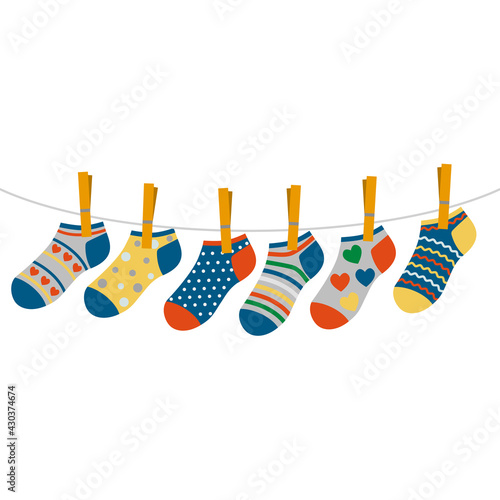 children's colored socks hang on a rope. concept of international day of children with down syndrome and premature babies