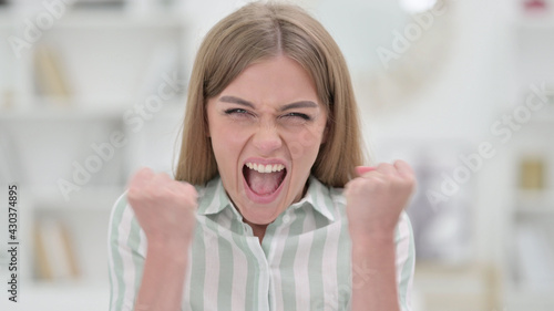 Portrait of Excited Young Woman Celebrating Success