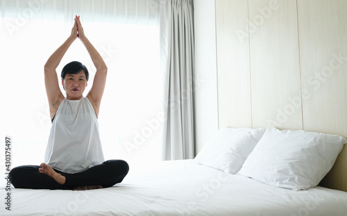 Asian women exercise by practicing yoga to stay fit.