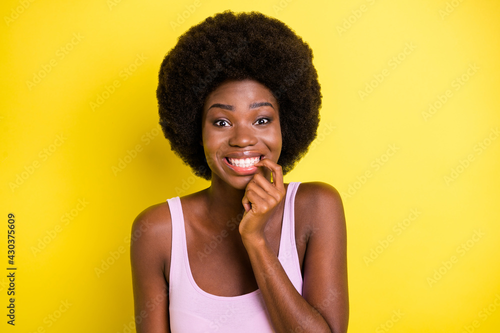 Photo of happy afro american amazed lady hold finger teeth excited novelty isolated on vibrant yellow color background Photo of happy afro american amazed lady hold finger teeth excited novelty isolated on vibrant yellow color background