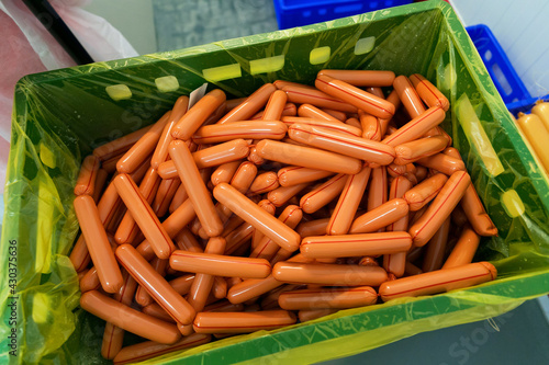 A lot of the fresh sausages in the big box in the meat plant.