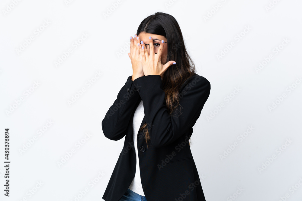 Business woman over isolated white background covering eyes and looking through fingers Business woman over isolated white background covering eyes and looking through fingers