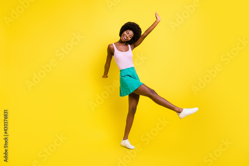 Full body photo of funky afro american lady dance wear pink tank-top carefree summer isolated on yellow color background