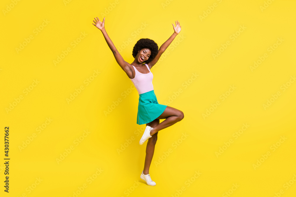 Full body profile side photo of dark skin attractive young woman raise hands celebrate success isolated on yellow color background