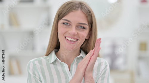Portrait of Excited Young Woman Clapping 