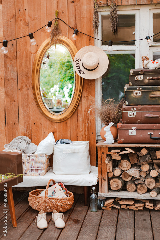 interior of the summer country cozy wooden rustic terrace with vintage accessories furniture. Atmospheric interior room for summer vacation in the country.