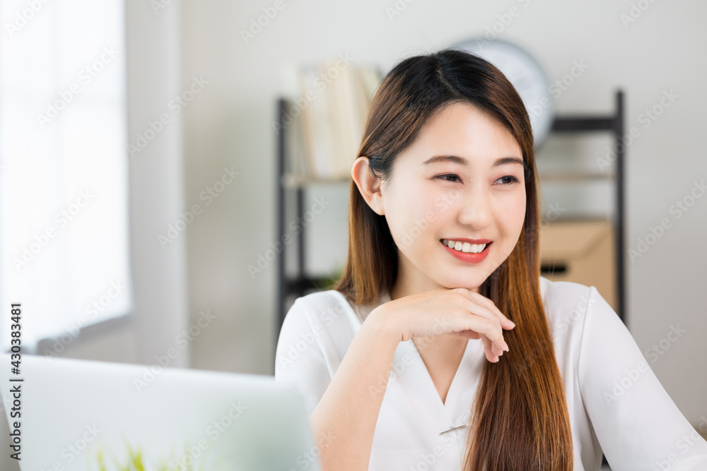Young asian beautiful business woman working with laptop sitting at home. Smiling charming happy young female doing homework meeting conference with team at home. Young asian beautiful business woman working with laptop sitting at home. Smiling charming happy young female doing homework meeting conference with team at home.