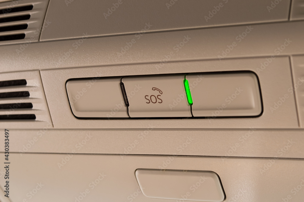 close-up - sos button in the car interior with a green light