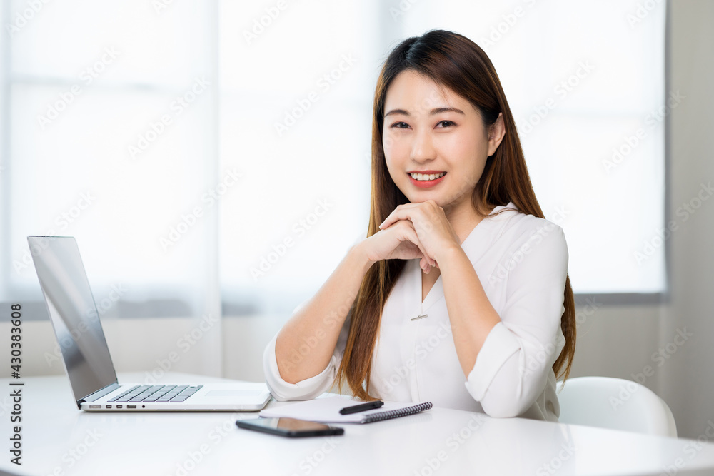 Young asian beautiful business woman working with laptop sitting at home. Smiling charming happy young female doing homework meeting conference with team at home. Young asian beautiful business woman working with laptop sitting at home. Smiling charming happy young female doing homework meeting conference with team at home.