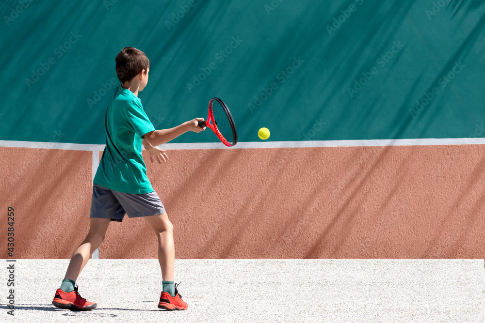 Child boy tennis player play tennis alone, practicing hitting technique,  training against the wall. Sports, games and leisure activities for  children outside. Copy space Stock Photo | Adobe Stock