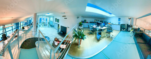 Panoramic view of modern office interior with desk and chairs