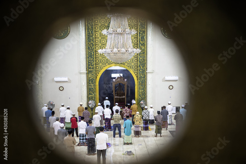 Situbondo, Indonesia - 26 April 2021 : indonesian muslim people (taraweeh) tarawih pray at Al Abror Mosque with social distancing photo