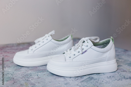 Sport white shoes on light background.