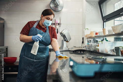 Fotografie Kitchen personnel responsible for cleaning and sanitizing highly-touched surface