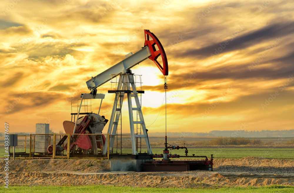Crude oil pump jack at oilfield on sunset backround. Fossil crude output and fuels oil production. Oil drill rig. Crude mining concept. Oil prices on the trading exchange. Crude oil pump jack at oilfield on sunset backround. Fossil crude output and fuels oil production. Oil drill rig. Crude mining concept. Oil prices on the trading exchange.