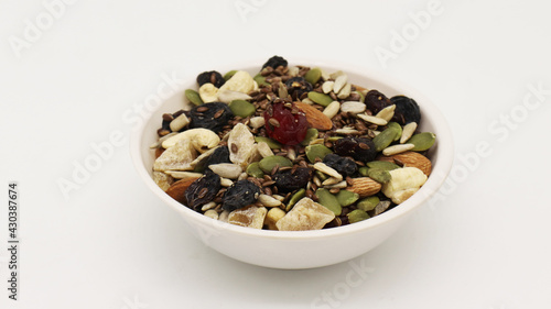 Healthy trail mix snack made of nuts (walnut, almond, peanut) and dried fruits (raisin, sultana) on iron scoop (Selective Focus, Focus on the front of the almond) © Kaushik