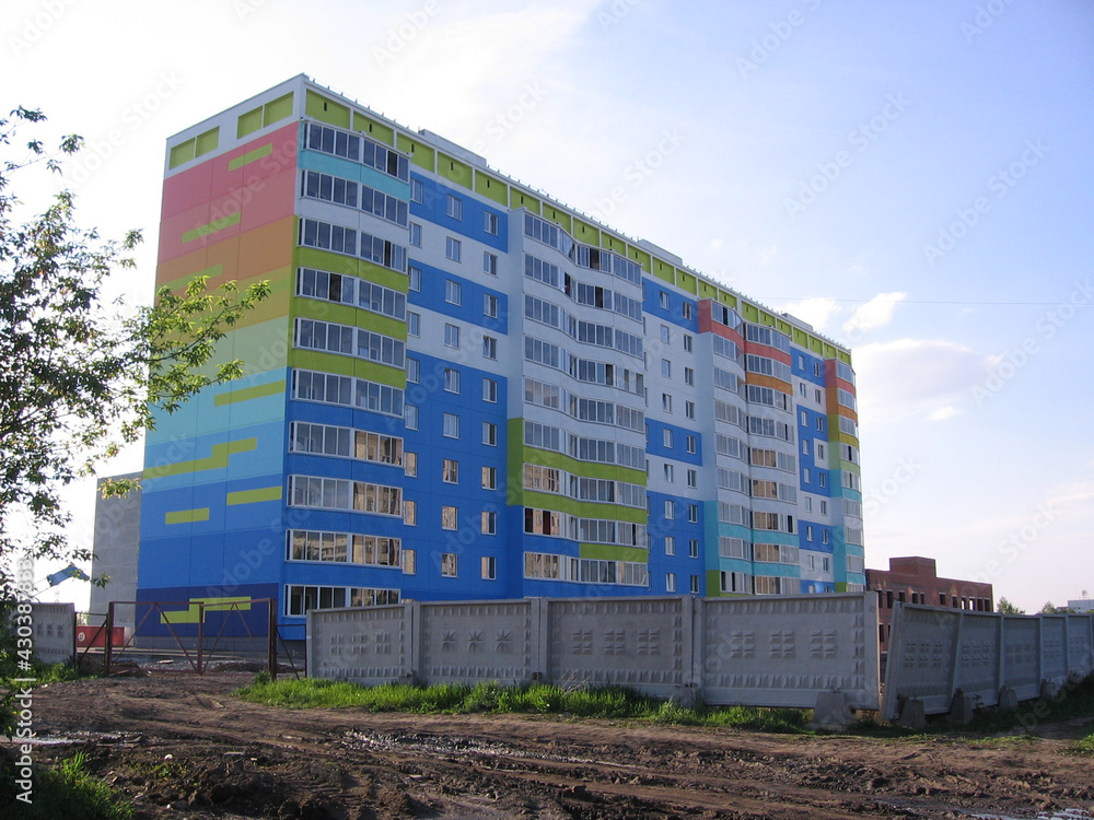 a bright multi-colored multi-storey residential building in the city of rainbow