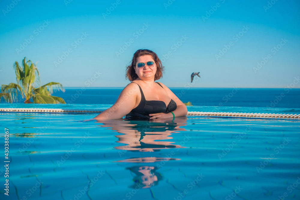  Plus size middle age woman in pool at Egypt, vacation and relax concept, travel to Africa