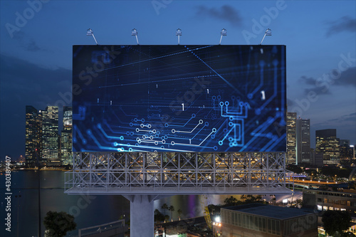 Information flow hologram on road billboard  night panorama city view of Singapore. The largest technological center in Southeast Asia. The concept of programming science.