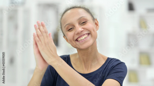 Portrait of Excited Young African Woman Clapping 