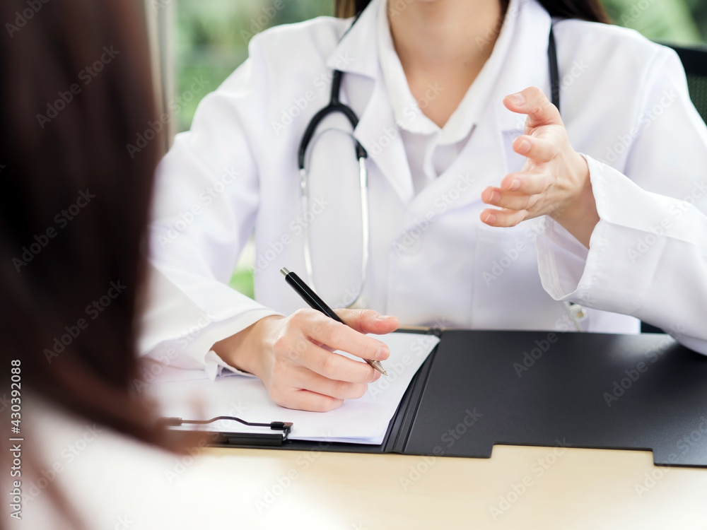 A close-up of the hand of a female doctor or nurse holding a pen is talking or explaining information or something for a patient... A close-up of the hand of a female doctor or nurse holding a pen is talking or explaining information or something for a patient...