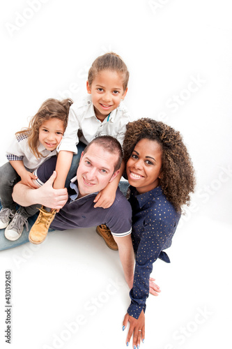 Happy multiracial family with two children, on the white background