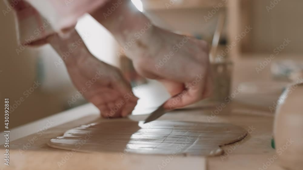 The woman crafts a ceramic object on the table on workshop. Pottery, handicrafts and creative skills. Traditional crafts concept. The woman crafts a ceramic object on the table on workshop. Pottery, handicrafts and creative skills. Traditional crafts concept.