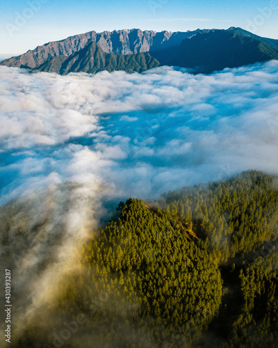 Aerial view clouds between mountains and forest in La Palma island, Canary Islands, Spain. photo