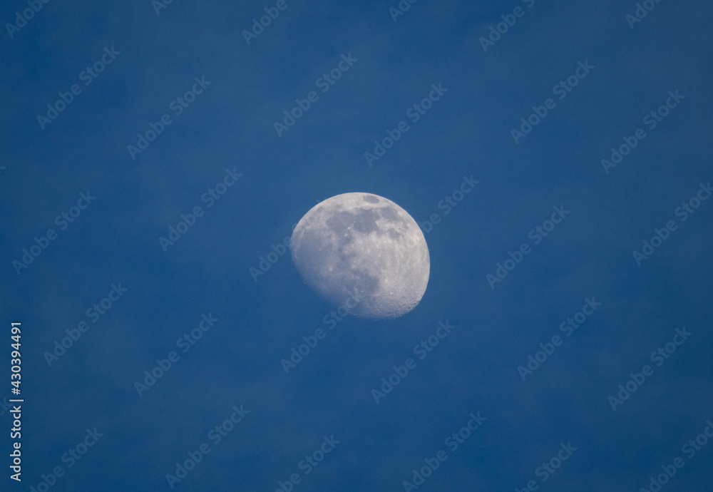Incomplete moon in cloudy sky