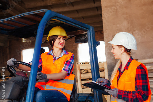 Young female warehouse workers solving working issues