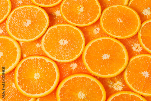 Slices of oranges as a background, top view.