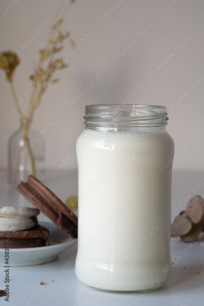 vaso o botella de leche sobre una mesa de color blanco, acompañado de alfajores tradicionales de argentina de dulce de leche con chocolate vaso o botella de leche sobre una mesa de color blanco, acompañado de alfajores tradicionales de argentina de dulce de leche con chocolate