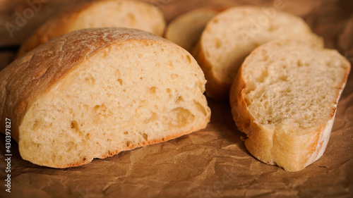 Ciabatta slices on craft paper. Fresh delicious pastries. Fresh homemade bread.