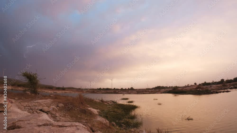 4K Timelapse shot of the clouds during the golden hour above the lake during the sunset at Wankaner, Gujarat, India 4K Timelapse shot of the clouds during the golden hour above the lake during the sunset at Wankaner, Gujarat, India