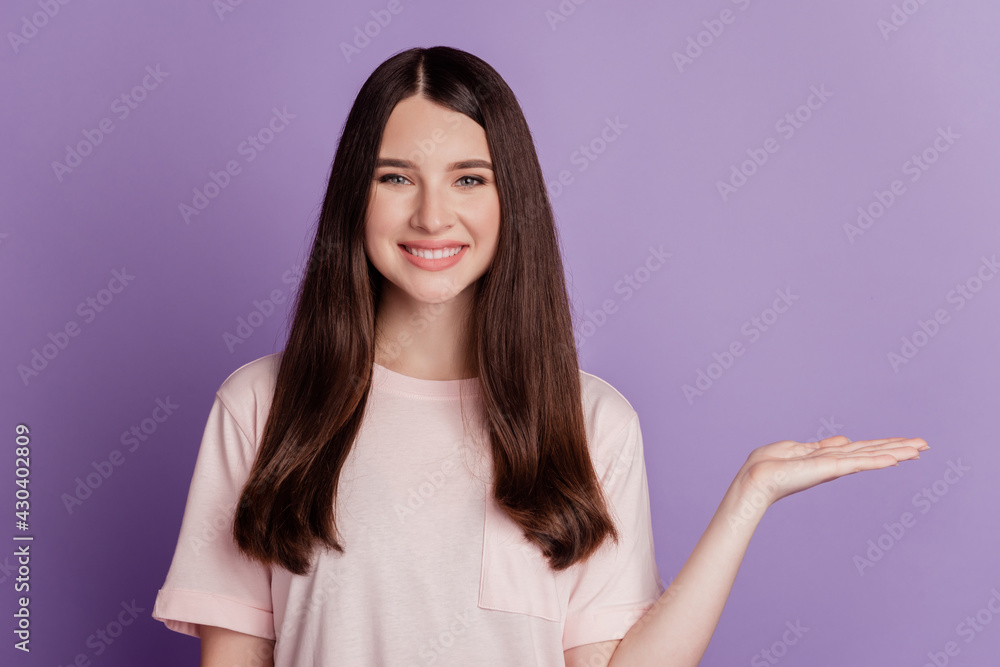 Photo of successful adviser hold palm presenting empty space on purple wall