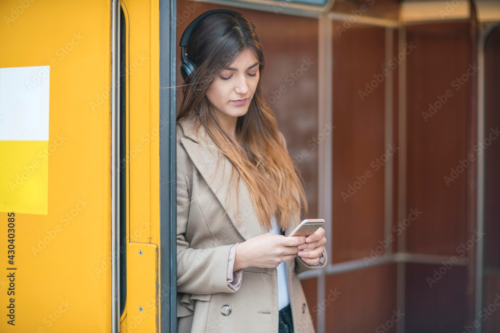 Germany, Berlin, Young woman using smart phone Germany, Berlin, Young woman using smart phone