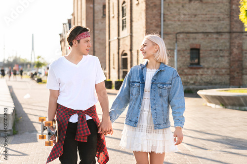 Wallpaper Mural Teenage couple with a longboard during their date in a city Torontodigital.ca