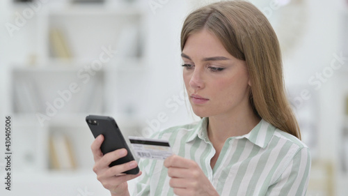Portrait of Young Woman making Online Payment on Smartphone 